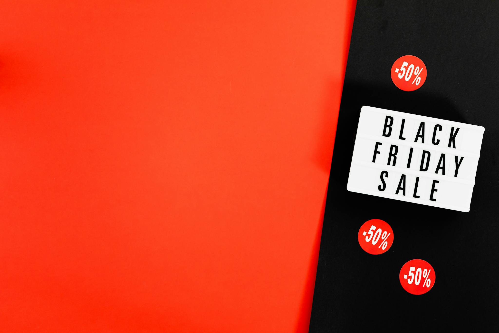 Black Friday sale advertisement with bold red background and discount signs.